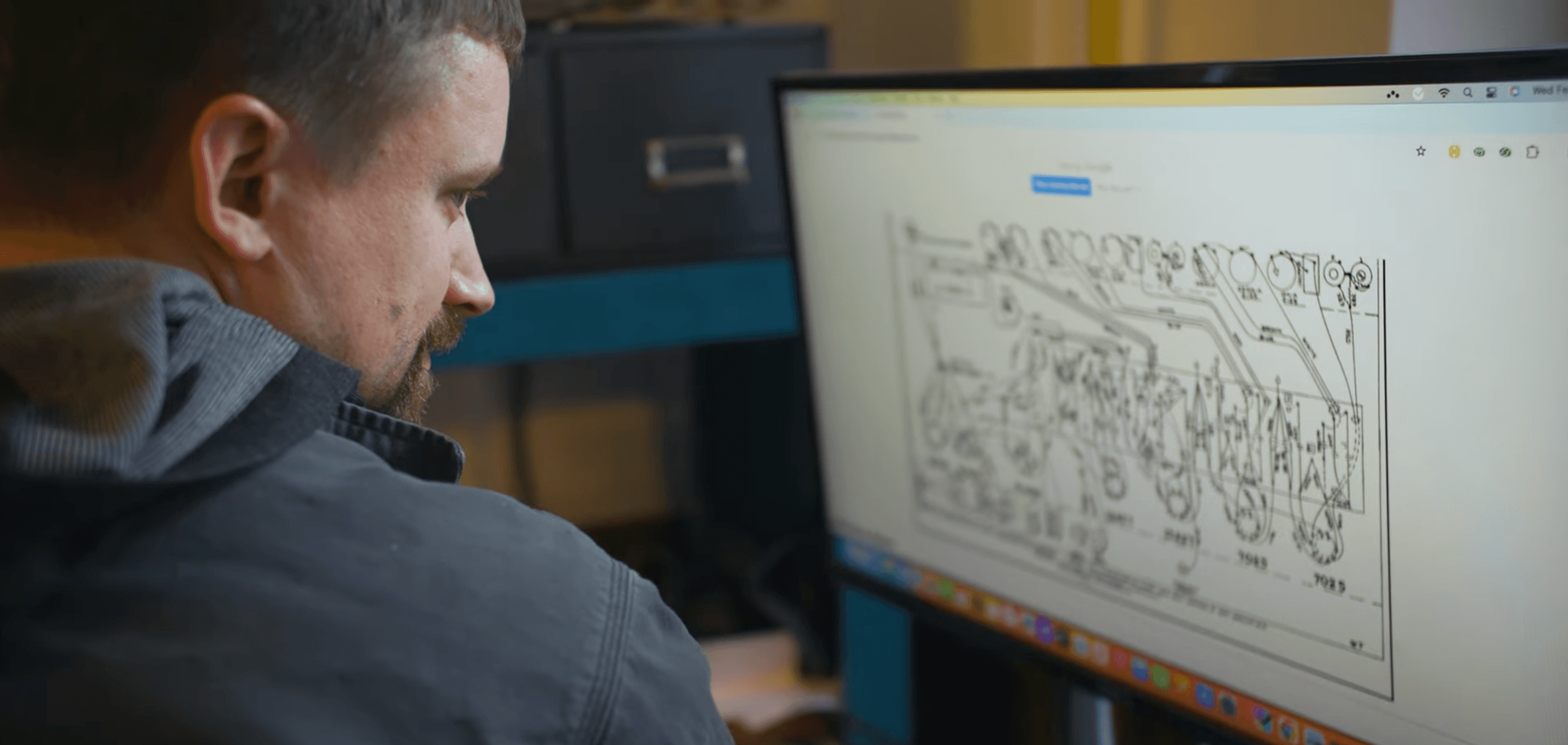 Nick Winnard analyzing a tube amplifier schematic at his workbench